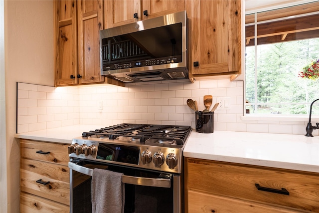 12520 Pinkham Creek Rd, Rexford, MT 59930 - kitchen featuring stainless steel appliances, brown cabinets, decorative backsplash, and light countertops