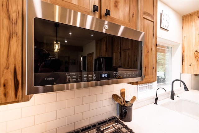 12520 Pinkham Creek Rd, Rexford, MT 59930 - kitchen featuring stainless steel microwave, a sink, and backsplash