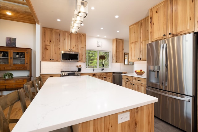 12520 Pinkham Creek Rd, Rexford, MT 59930 - kitchen with appliances with stainless steel finishes, backsplash, a sink, light countertops, and recessed lighting
