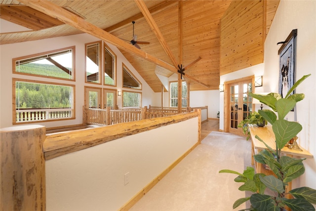 12520 Pinkham Creek Rd, Rexford, MT 59930 - hallway featuring french doors, wooden ceiling with exposed beams, carpet, and high vaulted ceiling