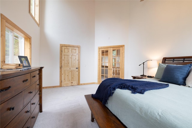 12520 Pinkham Creek Rd, Rexford, MT 59930 - bedroom with a high ceiling, carpet, baseboards, and french doors
