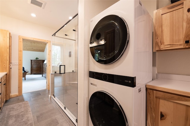 12520 Pinkham Creek Rd, Rexford, MT 59930 - laundry room with estacked washer and dryer, cabinet space, and recessed lighting