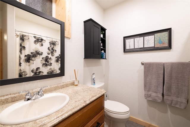 12520 Pinkham Creek Rd, Rexford, MT 59930 - bathroom with toilet, vanity, and baseboards