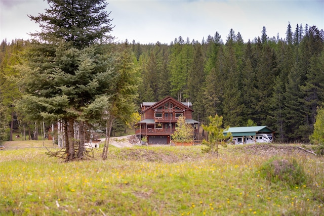 12520 Pinkham Creek Rd, Rexford, MT 59930 - back of house featuring a forest view, a garage, and a wooden deck