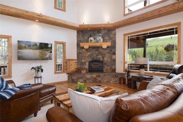 12520 Pinkham Creek Rd, Rexford, MT 59930 - living area featuring a towering ceiling, wood finished floors, healthy amount of natural light, a fireplace, and wainscoting