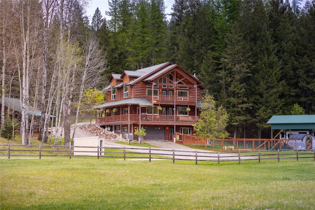 12520 Pinkham Creek Rd, Rexford, MT 59930 - rear view of house with a garage, a forest view, and a wooden deck