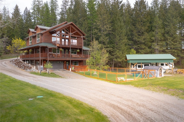 12520 Pinkham Creek Rd, Rexford, MT 59930 - view of front of home featuring an attached garage, dirt driveway, and a deck