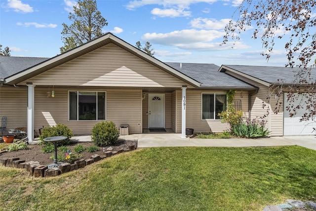 1091 Harmony Ct, Kalispell, MT 59901 - ranch-style home with a front lawn, a garage, and a shingled roof