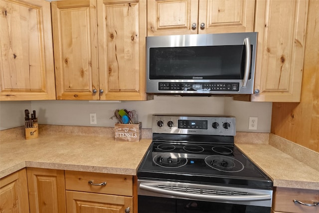 1091 Harmony Ct, Kalispell, MT 59901 - kitchen with stainless steel appliances, light countertops, and light brown cabinetry