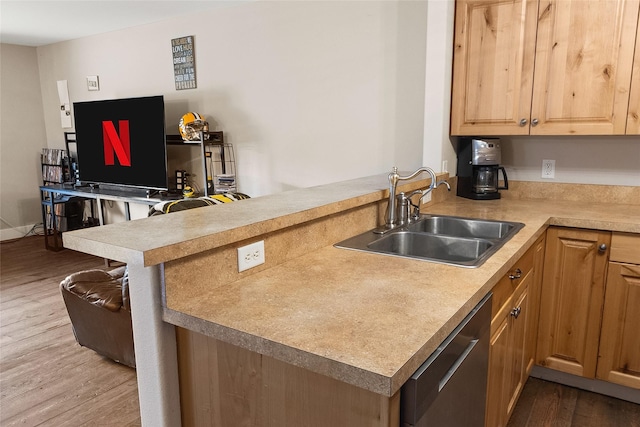 1091 Harmony Ct, Kalispell, MT 59901 - kitchen featuring dishwasher, a sink, a peninsula, wood finished floors, and light countertops