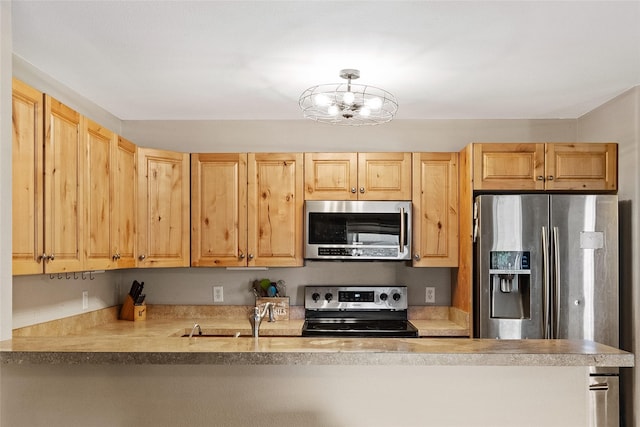 1091 Harmony Ct, Kalispell, MT 59901 - kitchen with stainless steel appliances, a chandelier, a sink, a peninsula, and light countertops