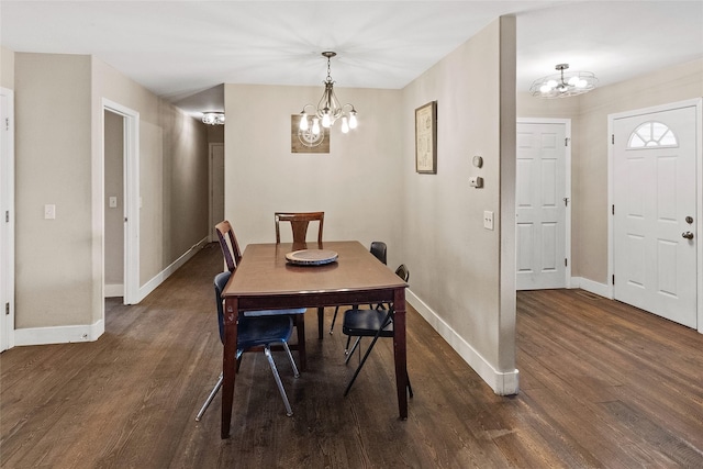 1091 Harmony Ct, Kalispell, MT 59901 - dining room featuring a chandelier, baseboards, and dark wood finished floors