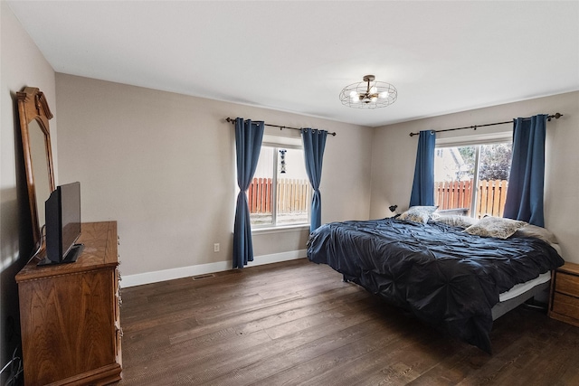 1091 Harmony Ct, Kalispell, MT 59901 - bedroom featuring dark wood-style flooring, a chandelier, and baseboards