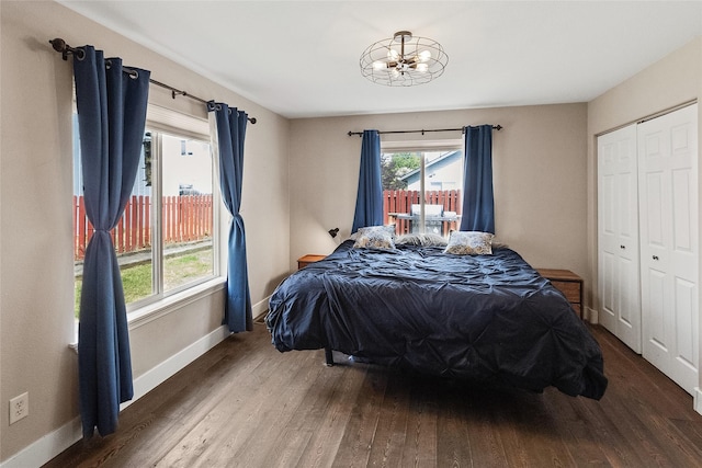 1091 Harmony Ct, Kalispell, MT 59901 - bedroom featuring wood finished floors, a chandelier, and baseboards