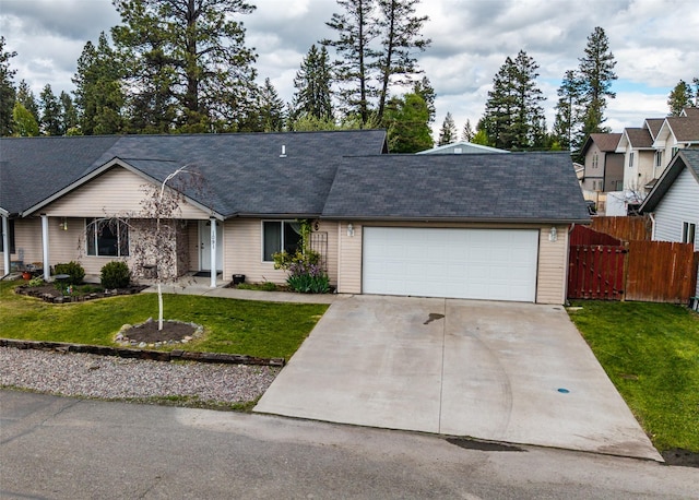 1091 Harmony Ct, Kalispell, MT 59901 - ranch-style house with an attached garage, driveway, a gate, and a shingled roof