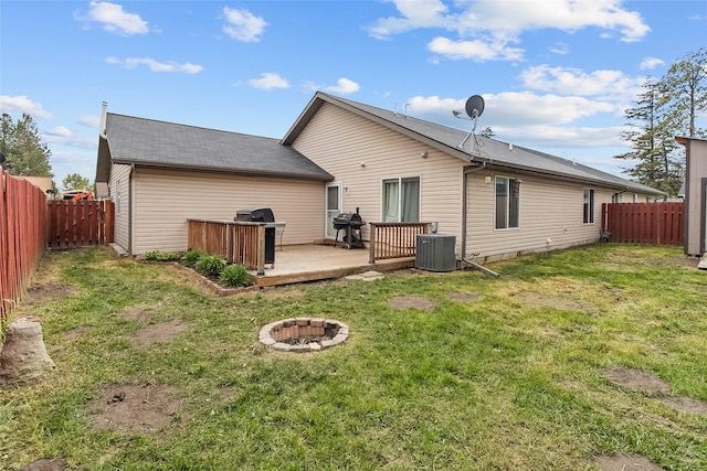 1091 Harmony Ct, Kalispell, MT 59901 - rear view of house with an outdoor fire pit, a wooden deck, and cooling unit