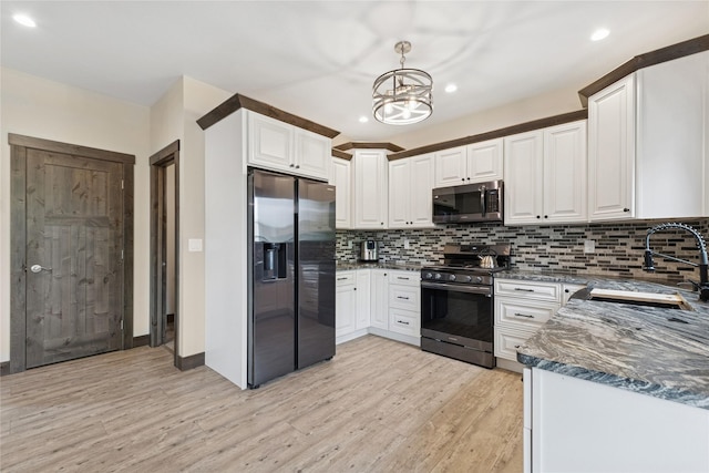 1066 Mill Creek Drive Mill Creek Drive, Bigfork, MT 59911 - kitchen featuring appliances with stainless steel finishes, a sink, light wood-type flooring, backsplash, and a chandelier