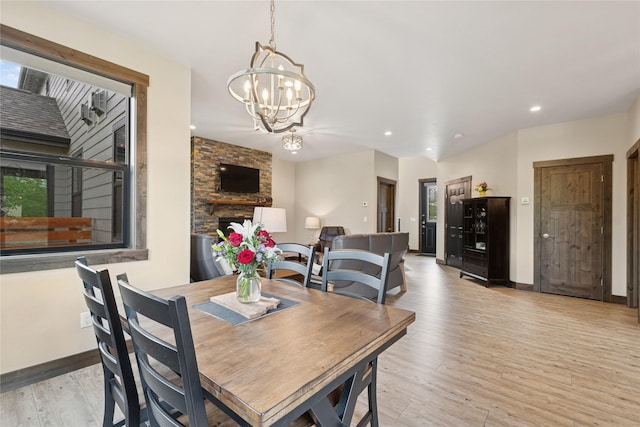 1066 Mill Creek Drive Mill Creek Drive, Bigfork, MT 59911 - dining space featuring a chandelier, light wood-style floors, recessed lighting, a fireplace, and baseboards