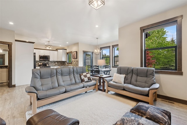 1066 Mill Creek Drive Mill Creek Drive, Bigfork, MT 59911 - living area featuring light wood-type flooring, recessed lighting, baseboards, and a chandelier