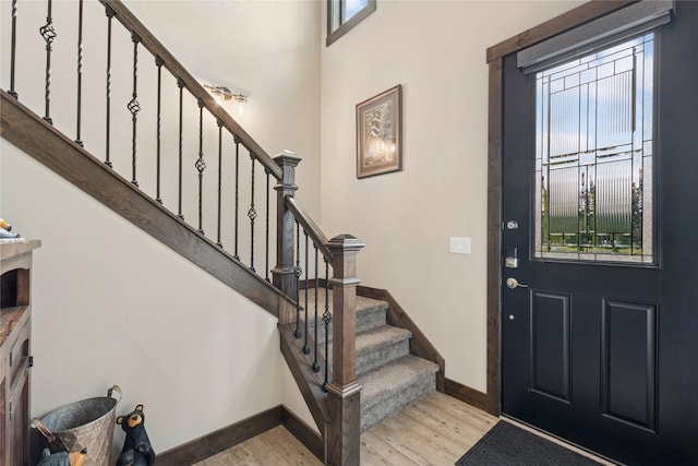 1066 Mill Creek Drive Mill Creek Drive, Bigfork, MT 59911 - foyer featuring wood finished floors, plenty of natural light, stairway, and baseboards