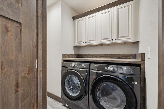 1066 Mill Creek Drive Mill Creek Drive, Bigfork, MT 59911 - laundry room with washing machine and dryer, cabinet space, and baseboards