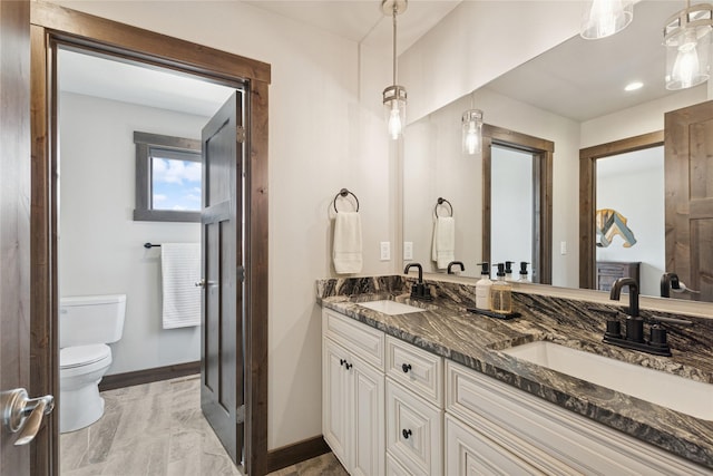 1066 Mill Creek Drive Mill Creek Drive, Bigfork, MT 59911 - full bathroom featuring toilet, baseboards, double vanity, and marble finish floors