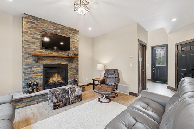 1066 Mill Creek Drive Mill Creek Drive, Bigfork, MT 59911 - living area with wood finished floors, baseboards, a stone fireplace, and recessed lighting