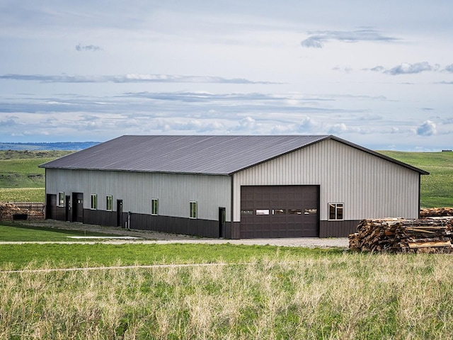 89 Wild Rose Trl, Roberts, MT 59070 - view of home's exterior featuring a detached garage, an outdoor structure, and an outbuilding