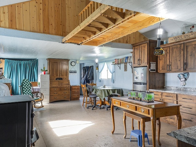 89 Wild Rose Trl, Roberts, MT 59070 - kitchen featuring pendant lighting and wood walls