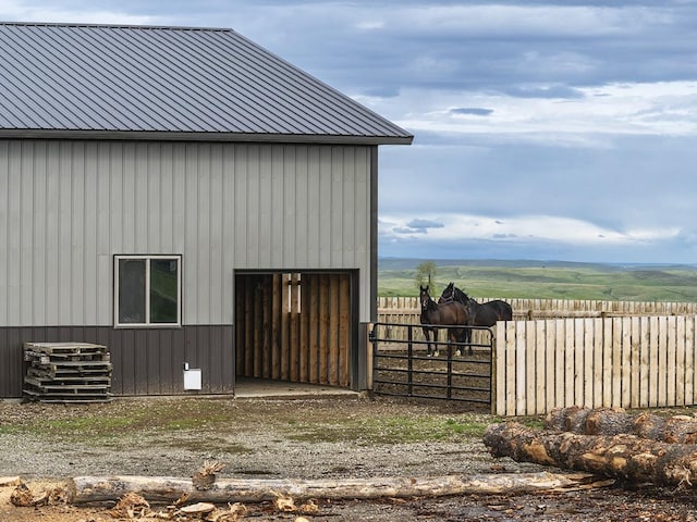 89 Wild Rose Trl, Roberts, MT 59070 - view of property exterior featuring an outdoor structure, metal roof, and a view of countryside