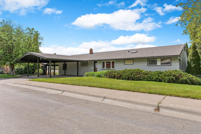 160 Sherwood Ln, Kalispell, MT 59901 - ranch-style house with a chimney, a front lawn, and a carport
