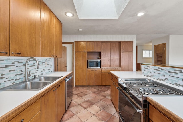 160 Sherwood Ln, Kalispell, MT 59901 - kitchen with appliances with stainless steel finishes, a sink, light countertops, and backsplash
