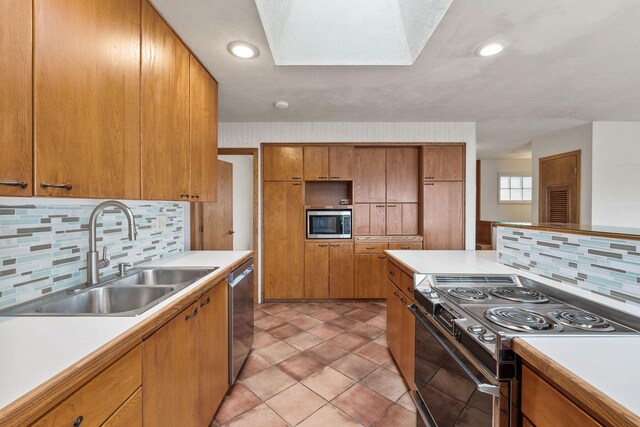 160 Sherwood Ln, Kalispell, MT 59901 - kitchen featuring appliances with stainless steel finishes, light countertops, tasteful backsplash, and brown cabinets