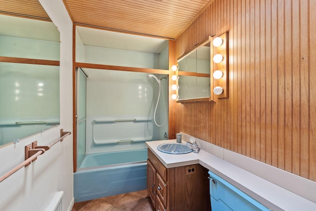 160 Sherwood Ln, Kalispell, MT 59901 - bathroom featuring vanity, washtub / shower combination, wood walls, and tile patterned floors