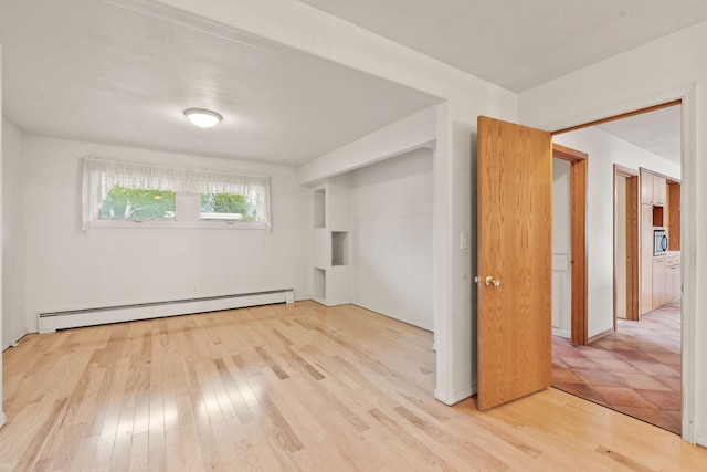 160 Sherwood Ln, Kalispell, MT 59901 - unfurnished room with a baseboard radiator and light wood-style floors