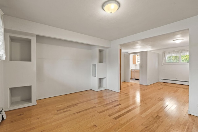 160 Sherwood Ln, Kalispell, MT 59901 - unfurnished living room with a baseboard radiator and light wood-type flooring