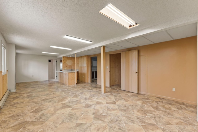 160 Sherwood Ln, Kalispell, MT 59901 - finished basement featuring a textured ceiling, stone finish floors, and bar