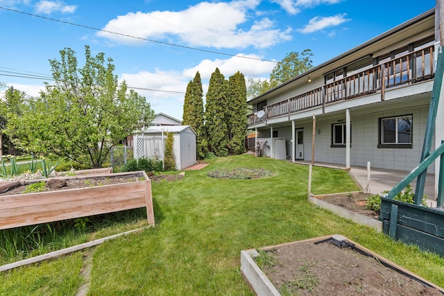 160 Sherwood Ln, Kalispell, MT 59901 - view of green lawn with a garden and a deck