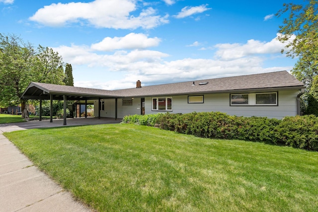 160 Sherwood Ln, Kalispell, MT 59901 - ranch-style home with a front lawn, a carport, a chimney, and driveway