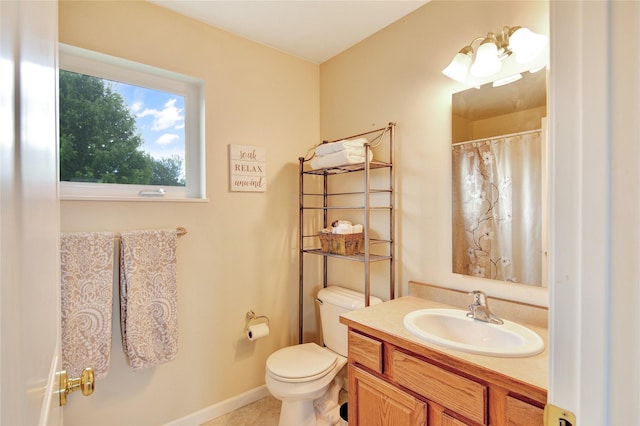 2795 Renae Ct, Missoula, MT 59804 - full bath with vanity, toilet, baseboards, tile patterned flooring, and a shower with curtain