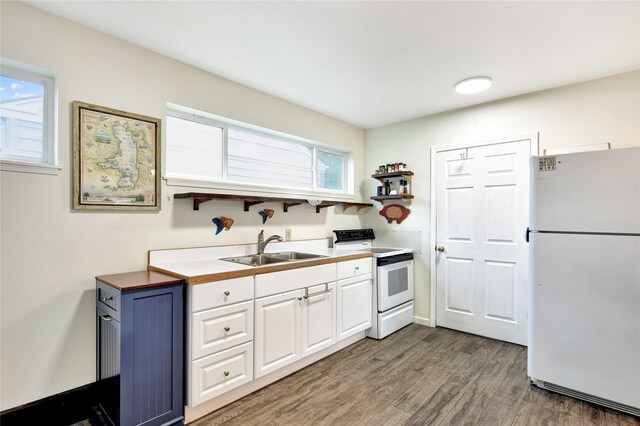 2795 Renae Ct, Missoula, MT 59804 - kitchen with white appliances, a sink, wood finished floors, and white cabinetry