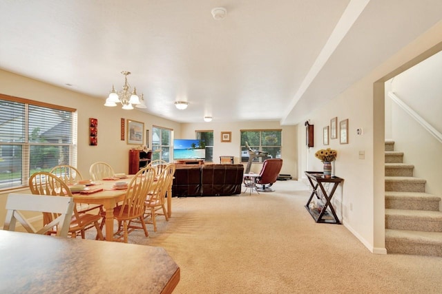 2795 Renae Ct, Missoula, MT 59804 - carpeted dining room with plenty of natural light, a chandelier, and stairway
