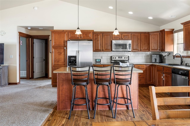 89 Alyvia Ln, Butte, MT 59701 - kitchen featuring stainless steel appliances, lofted ceiling, a sink, a kitchen island, and light countertops