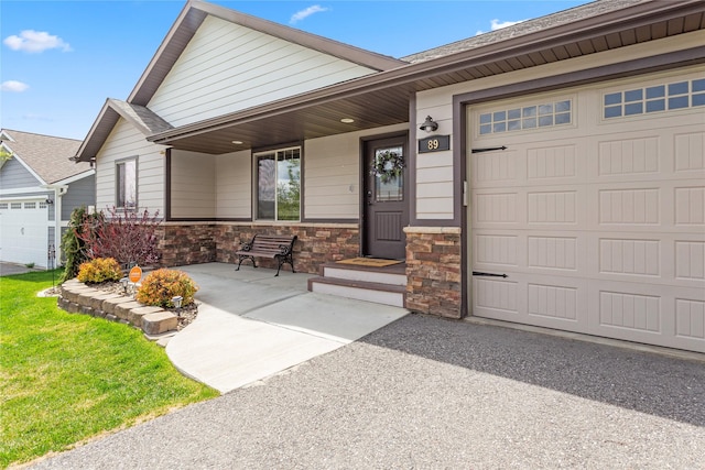 89 Alyvia Ln, Butte, MT 59701 - single story home with an attached garage, stone siding, a porch, and roof with shingles