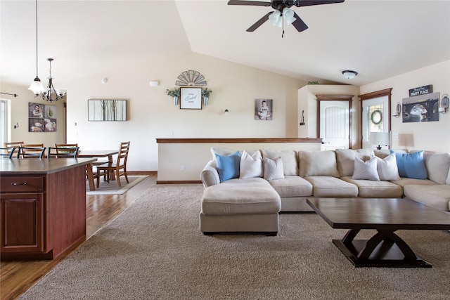 89 Alyvia Ln, Butte, MT 59701 - living room with wood finished floors, vaulted ceiling, ceiling fan, a chandelier, and baseboards