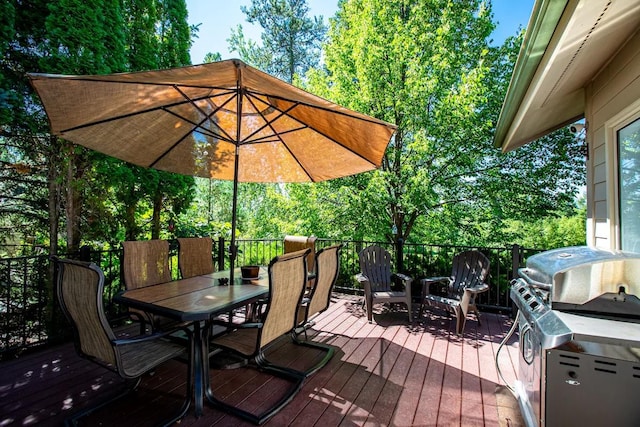883 Saint Andrews Dr, Columbia Falls, MT 59912 - wooden terrace featuring outdoor dining space, grilling area, and view of wooded area