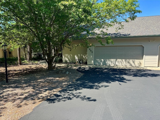 883 Saint Andrews Dr, Columbia Falls, MT 59912 - view of front facade featuring asphalt driveway and a garage