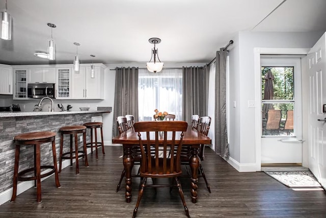 883 Saint Andrews Dr, Columbia Falls, MT 59912 - dining area with healthy amount of natural light, baseboards, and dark wood finished floors