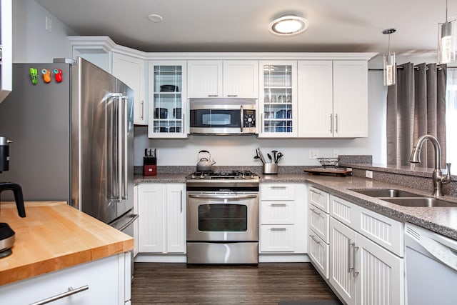 883 Saint Andrews Dr, Columbia Falls, MT 59912 - kitchen with stainless steel appliances, a sink, white cabinets, and butcher block countertops