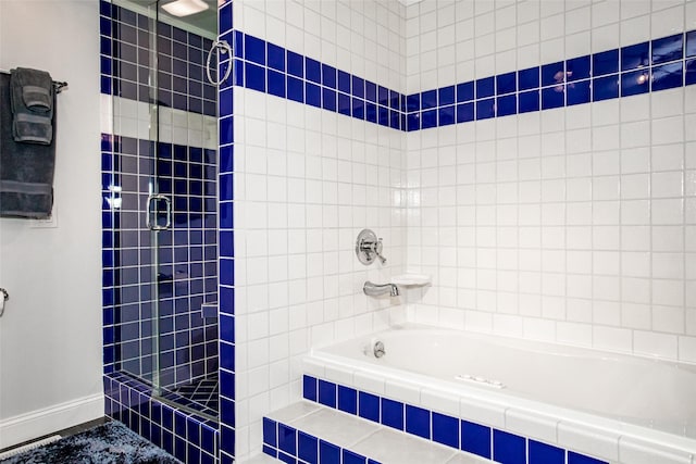 883 Saint Andrews Dr, Columbia Falls, MT 59912 - full bath with tiled shower, a relaxing tiled tub, and baseboards